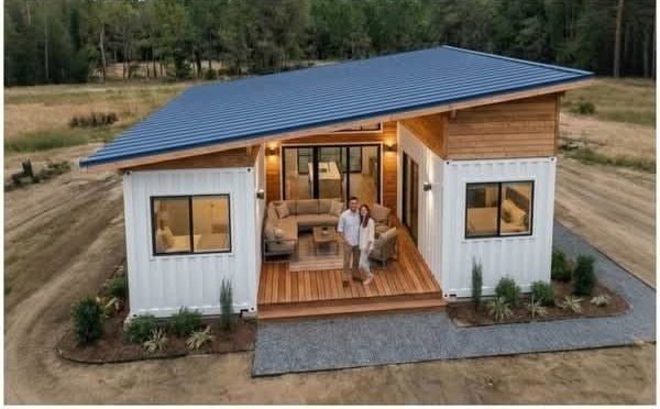 The Aspen container home exterior with wood deck and seating at dusk