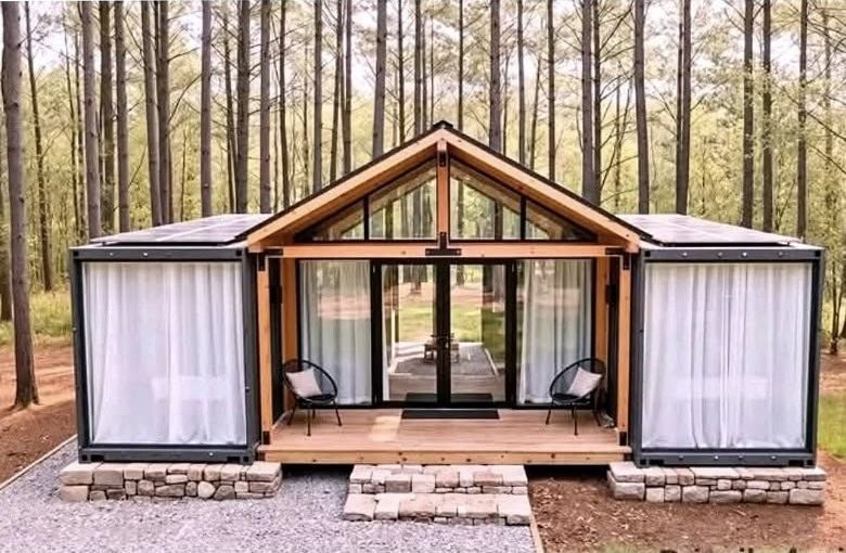The Canopy container home with a central glass gable great room between two container wings and solar panels
