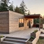 The Horizon container home at sunset with a covered wood deck